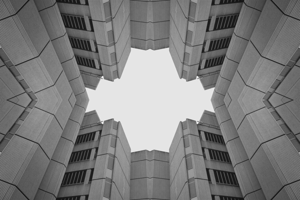 Symmetrical view of modern buildings against sky